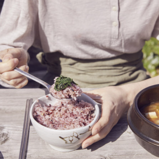 A Korean meal with rice and soup, representing care and connection in Korean food culture