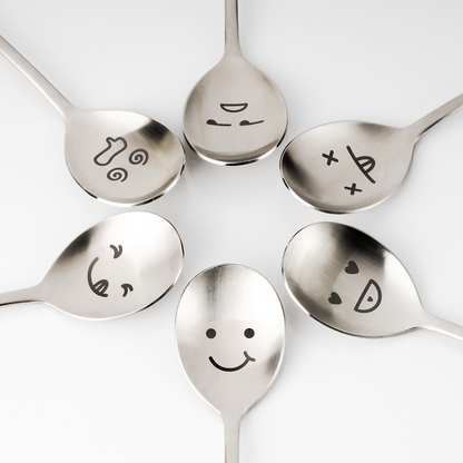 Six spoons with different expressions are gathered in the middle.