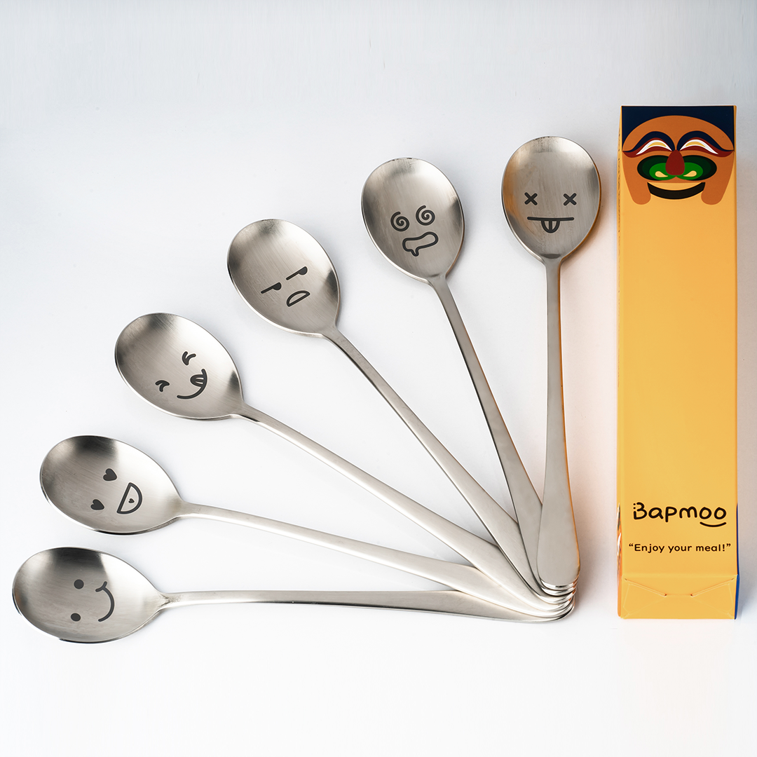 Six spoons are fanned out, and a packaging box with a Hahoe mask design is next to them.