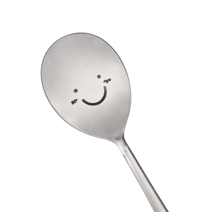 A spoon with a happy face is prominently in the center.