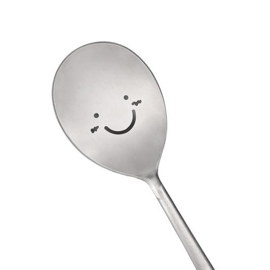 A spoon with a happy face is prominently in the center.