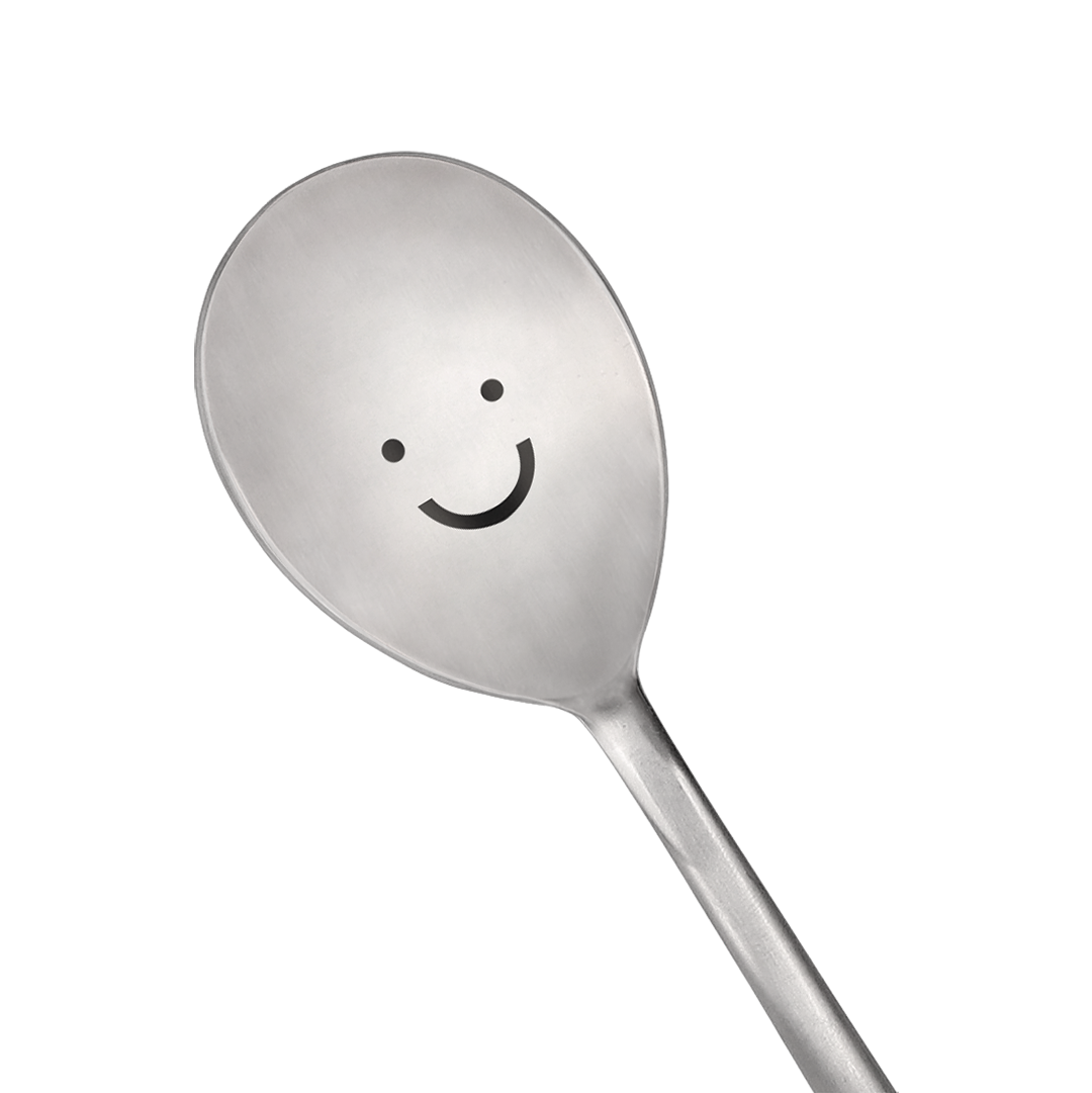 A spoon with a smiling face is prominently in the center.